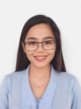 A woman with glasses smiling for the camera.