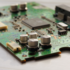 A close up of the electronics on top of a green board.